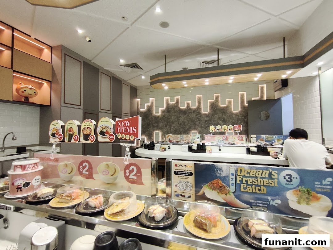 Interior view of Sushi Express, featuring a vibrant conveyor belt with fresh sushi and promotional displays.