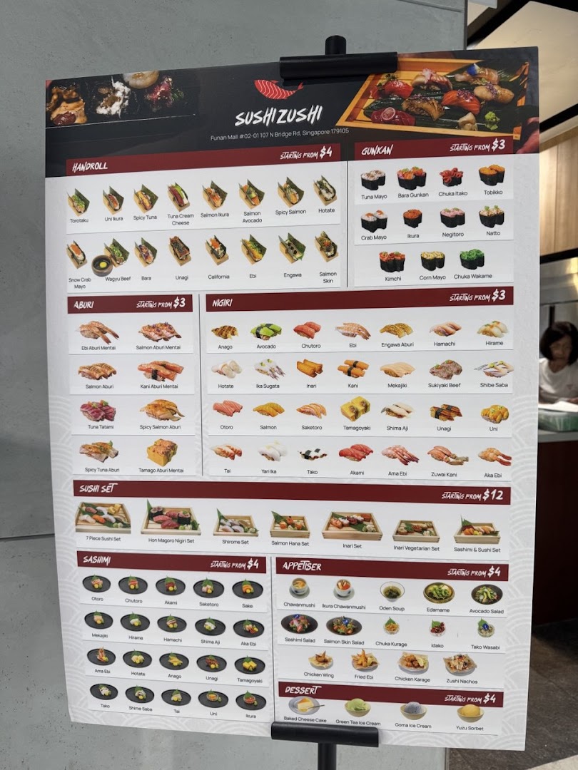 A detailed menu board for Sushi Zushi, showcasing various sushi, sashimi, and appetizer options.