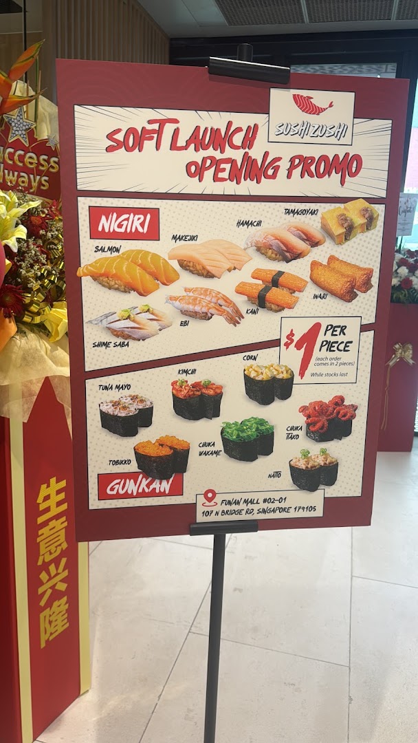 A promotional menu board for Sushi Zushi's soft launch, featuring various sushi types at $1 per piece.