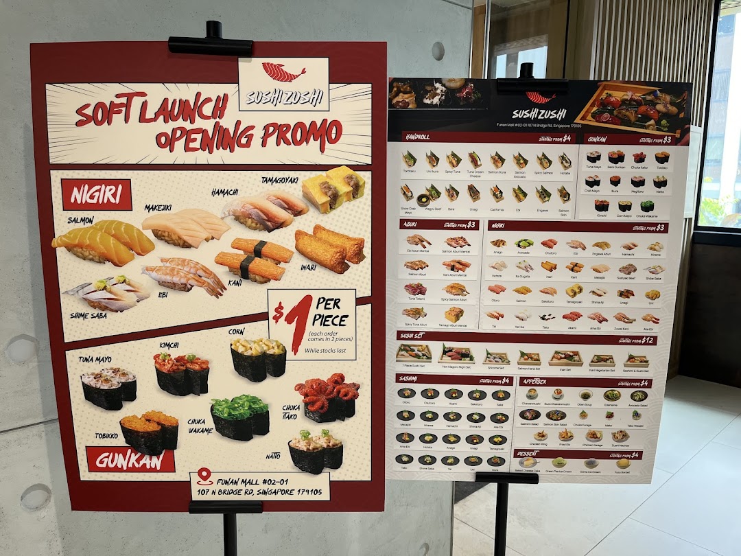 Two display boards showcasing Sushi Zushi's soft launch promotions and extensive menu offerings.