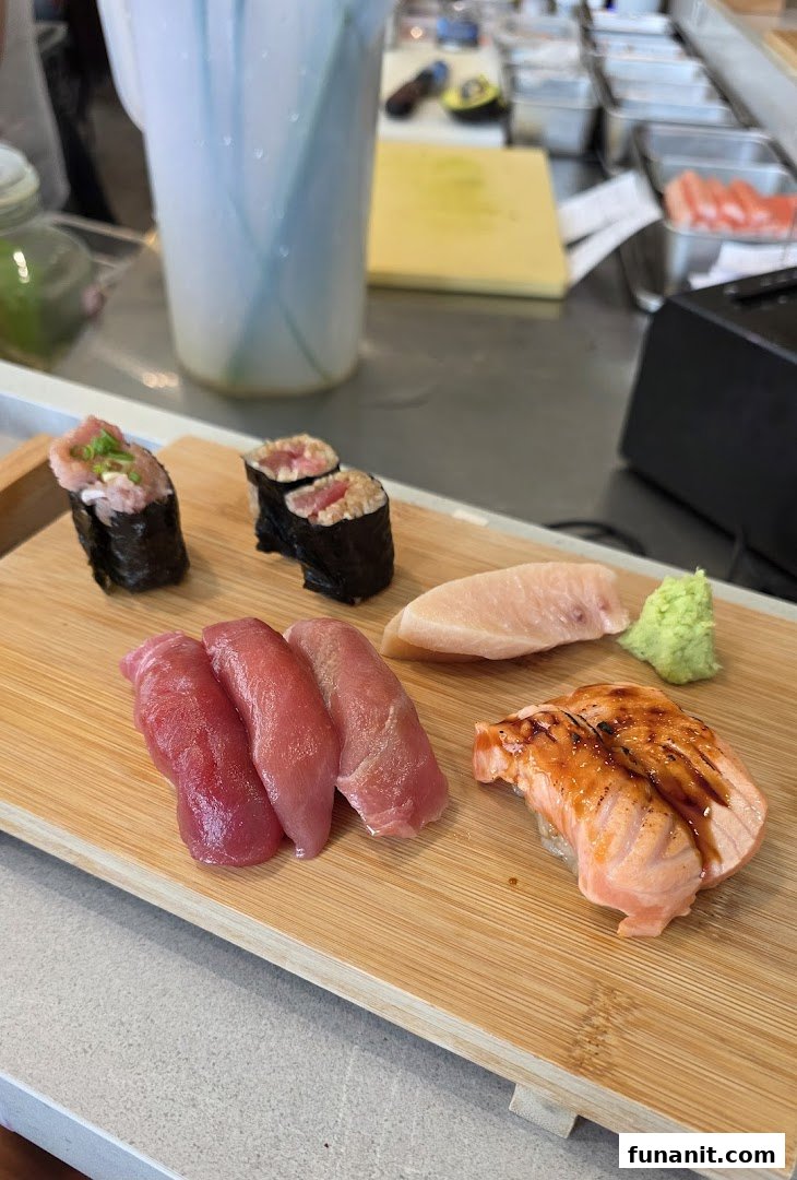 A delicious assortment of fresh sushi and sashimi served on a wooden board.
