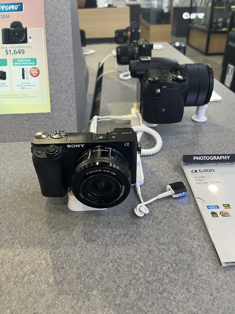 A display of Sony cameras, including the Alpha 6400, on a counter inside T K Foto Technic.