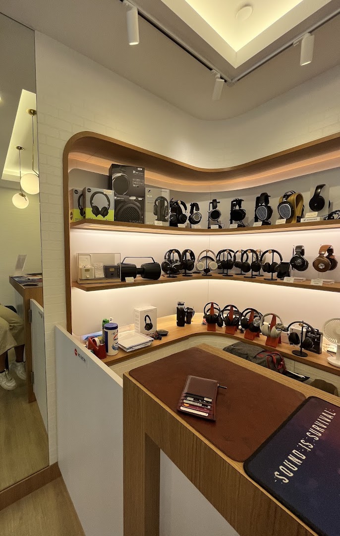 An interior view of T K Foto Technic Pte Ltd Funan, showcasing a wide array of headphones and audio equipment.