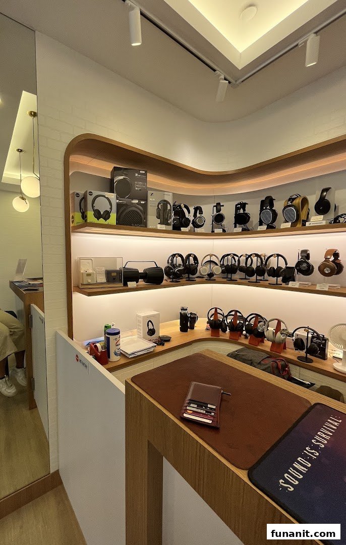 An interior view of T K Foto Technic Pte Ltd Funan, showcasing a wide array of headphones and audio equipment.