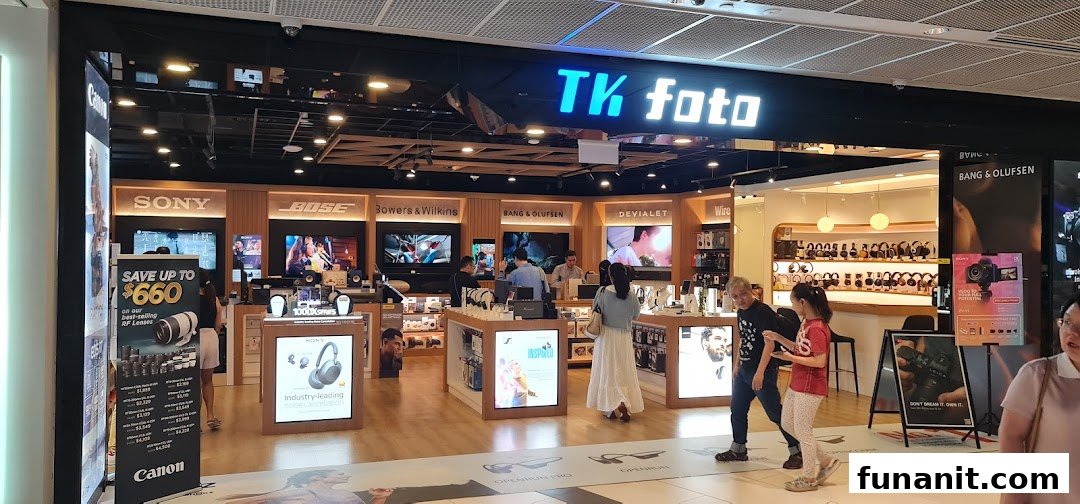 The vibrant storefront of TK Foto, showcasing premium cameras, audio, and electronics brands.