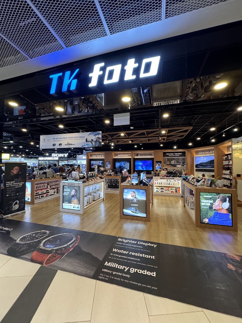 An interior view of TK Foto Technic, showcasing various electronics, cameras, and audio equipment displays.