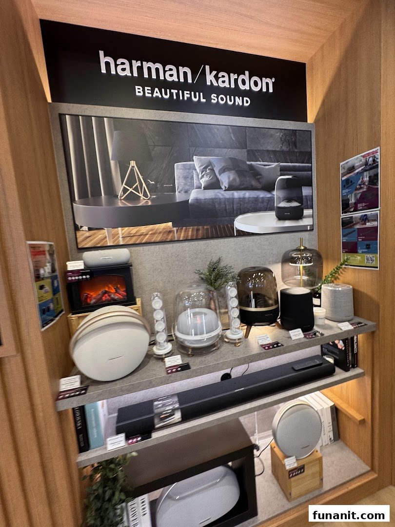 A display of Harman/Kardon audio products, including speakers and soundbars, showcasing beautiful sound technology.