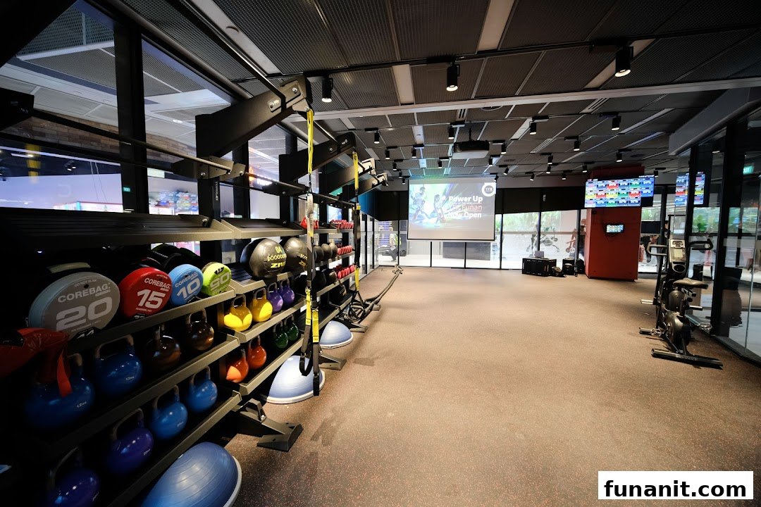 An interior view of TFX Fitness, showcasing a spacious workout area with various weights and fitness equipment.
