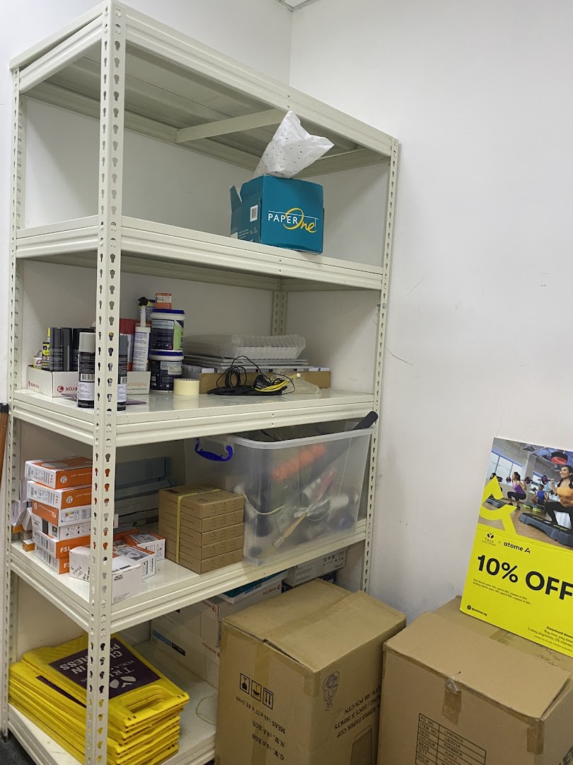 An interior shot of a storage area within TFX Fitness, featuring shelves stocked with various supplies and boxes.