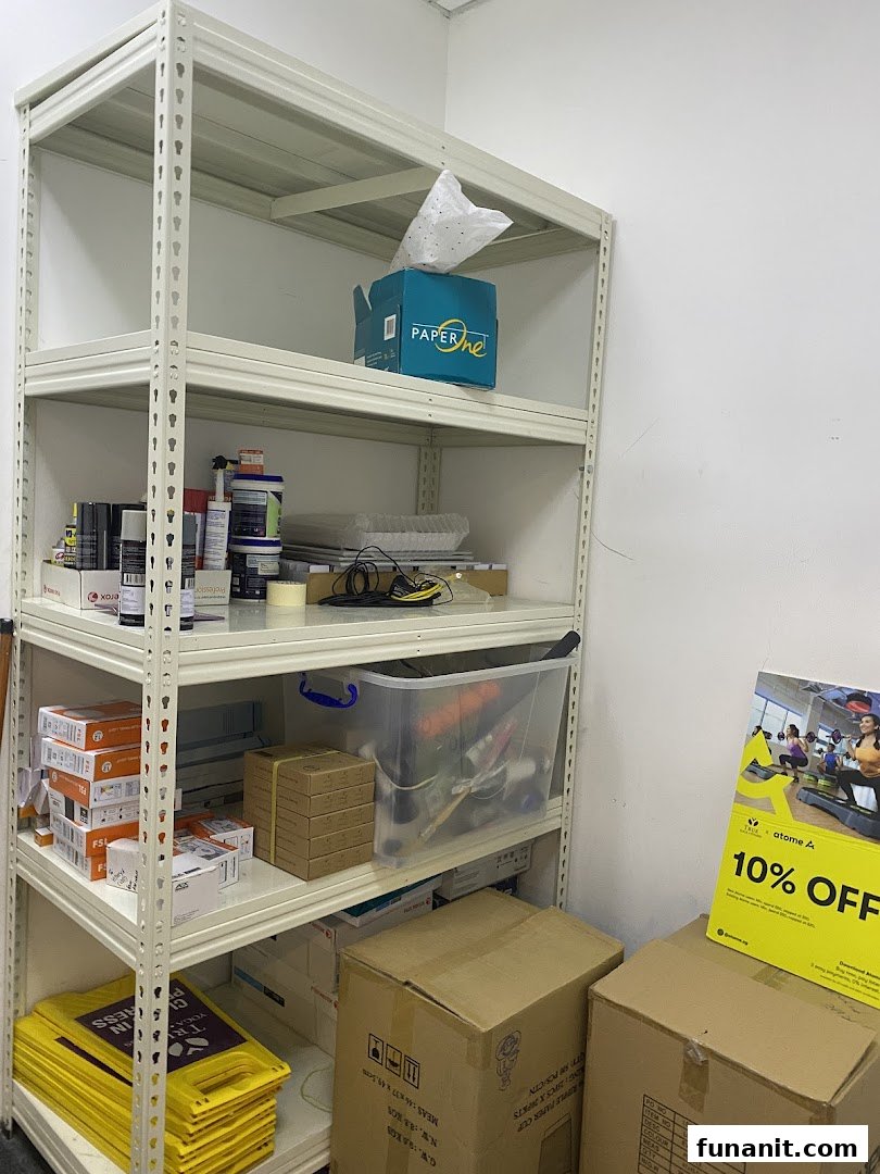 An interior shot of a storage area within TFX Fitness, featuring shelves stocked with various supplies and boxes.