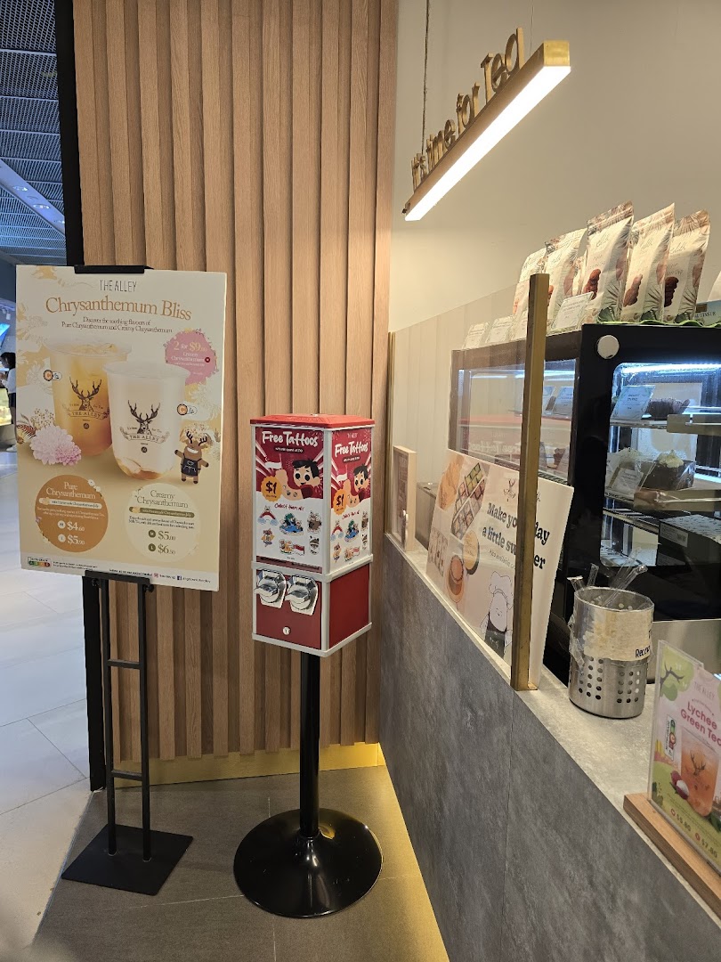 Interior view of The Alley bubble tea shop featuring a promotional menu stand and counter.
