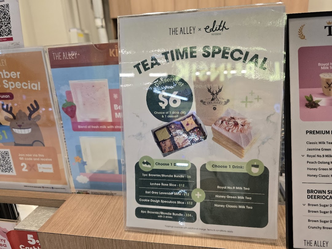 A display of promotional menus at The Alley, featuring a tea time special with drinks and desserts.