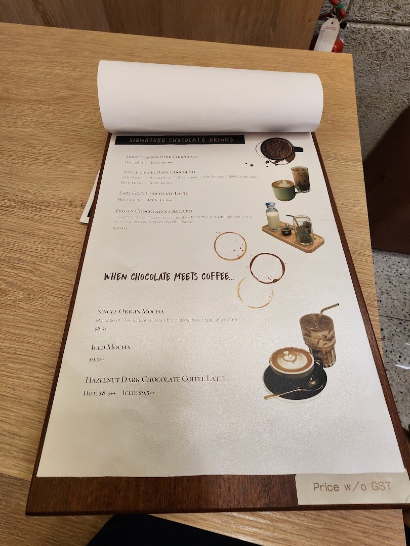 A close-up view of a menu from The Dark Gallery, featuring chocolate and coffee drinks.