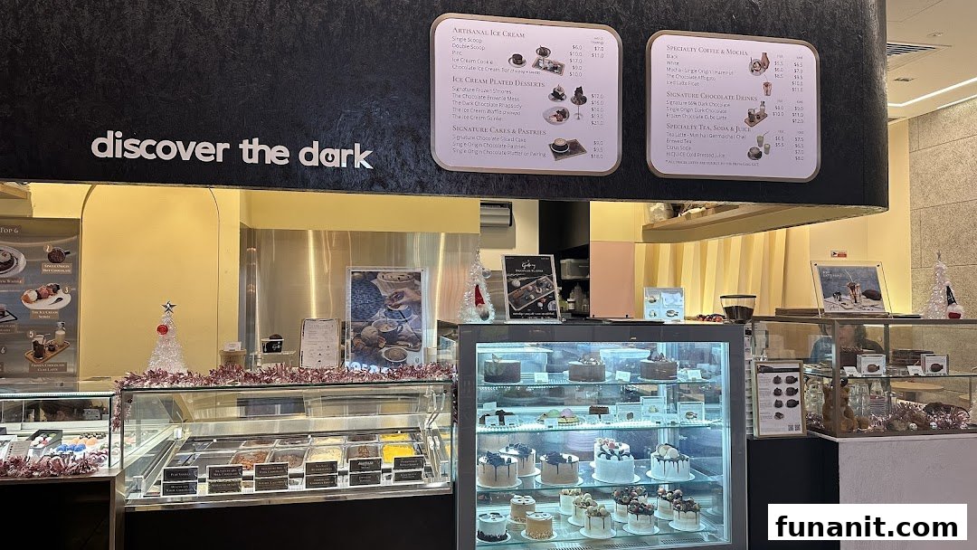 An inviting interior view of The Dark Gallery, showcasing ice cream, cakes, and menu boards.