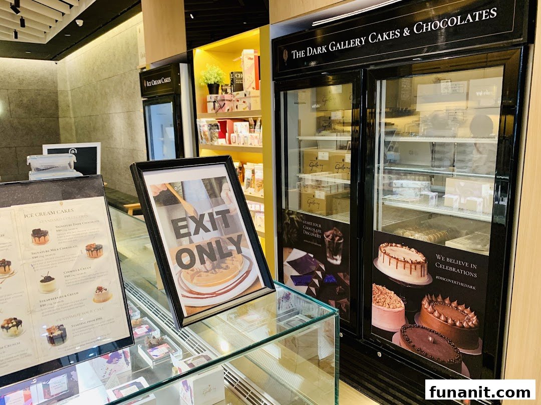 Interior view of The Dark Gallery, showcasing cakes, chocolates, and an ice cream cake menu.