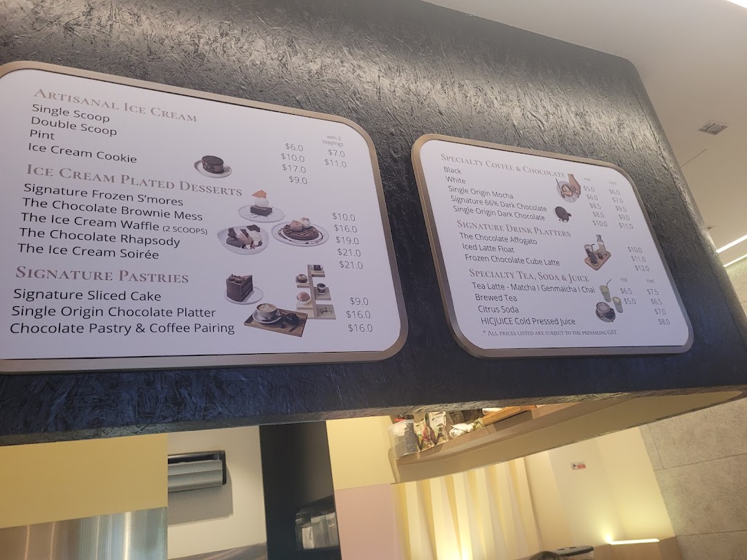 A detailed menu board showcasing artisanal ice cream, plated desserts, pastries, coffee, chocolate, and specialty drinks.