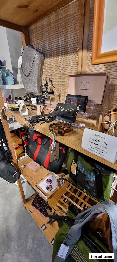 A wooden display shelf showcasing eco-friendly bags, accessories, and handcrafted wooden items.