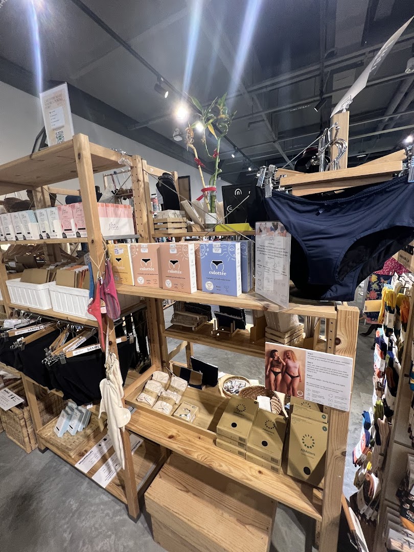 An interior shot of The Green Collective SG, showcasing sustainable period underwear and eco-friendly products on wooden shelves.