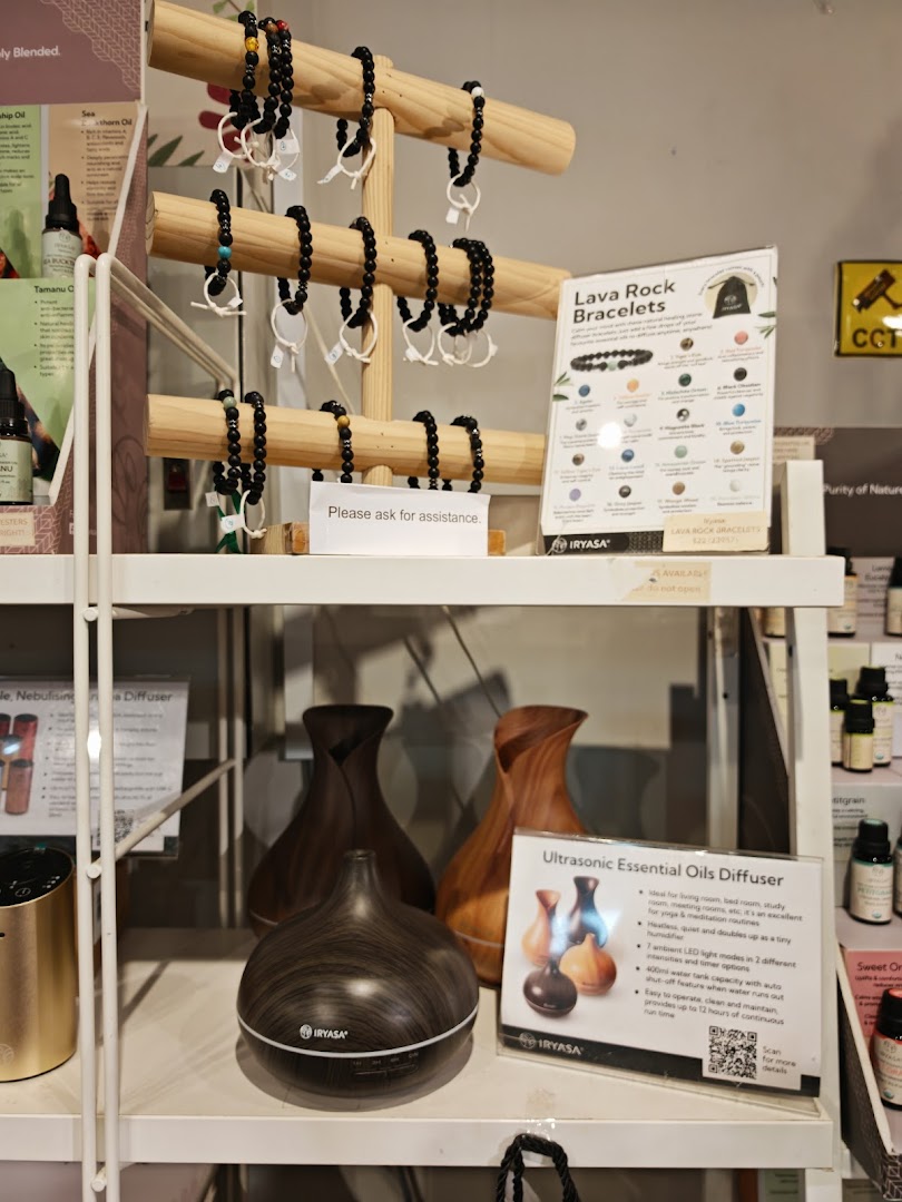 A retail display featuring lava rock bracelets and ultrasonic essential oil diffusers.