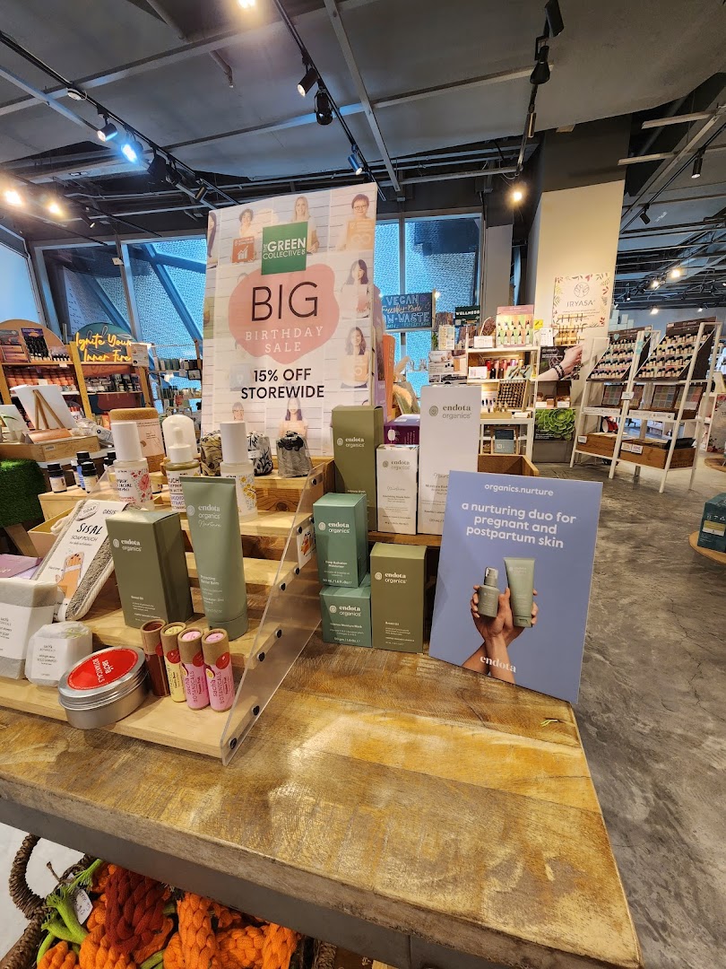 An in-store display at The Green Collective SG featuring organic beauty products and a 'Big Birthday Sale' sign.