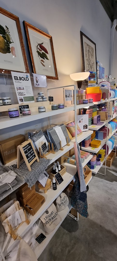 Shelves display a variety of eco-friendly home and personal care products, including natural deodorants and laundry items.