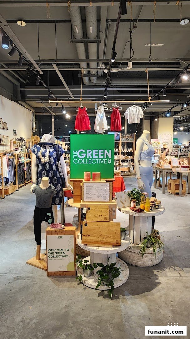 An interior shot of The Green Collective SG, featuring mannequins, clothing, and a central display.