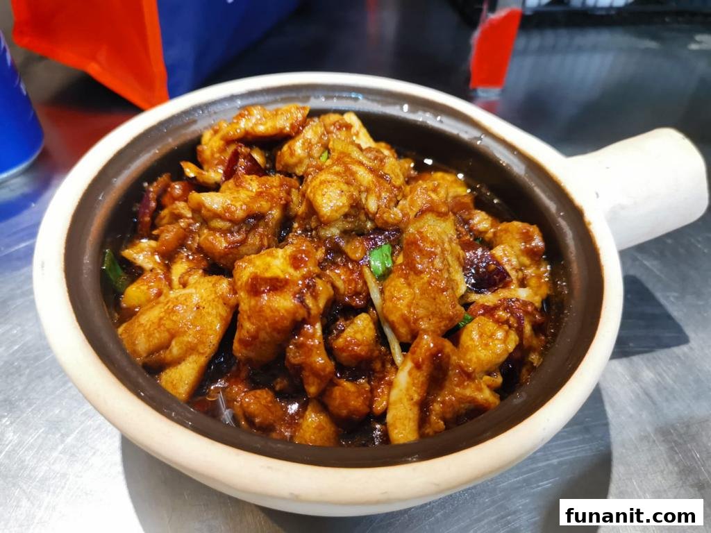 A close-up of a delicious claypot chicken dish served in a traditional pot.