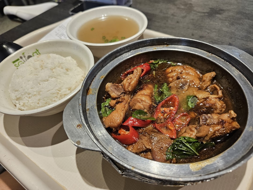A delicious claypot chicken dish with rice and soup, served on a tray.