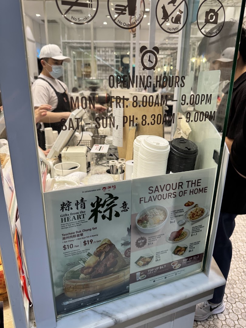 A Toast Box counter displaying opening hours, promotional food sets, and menu items with prices.