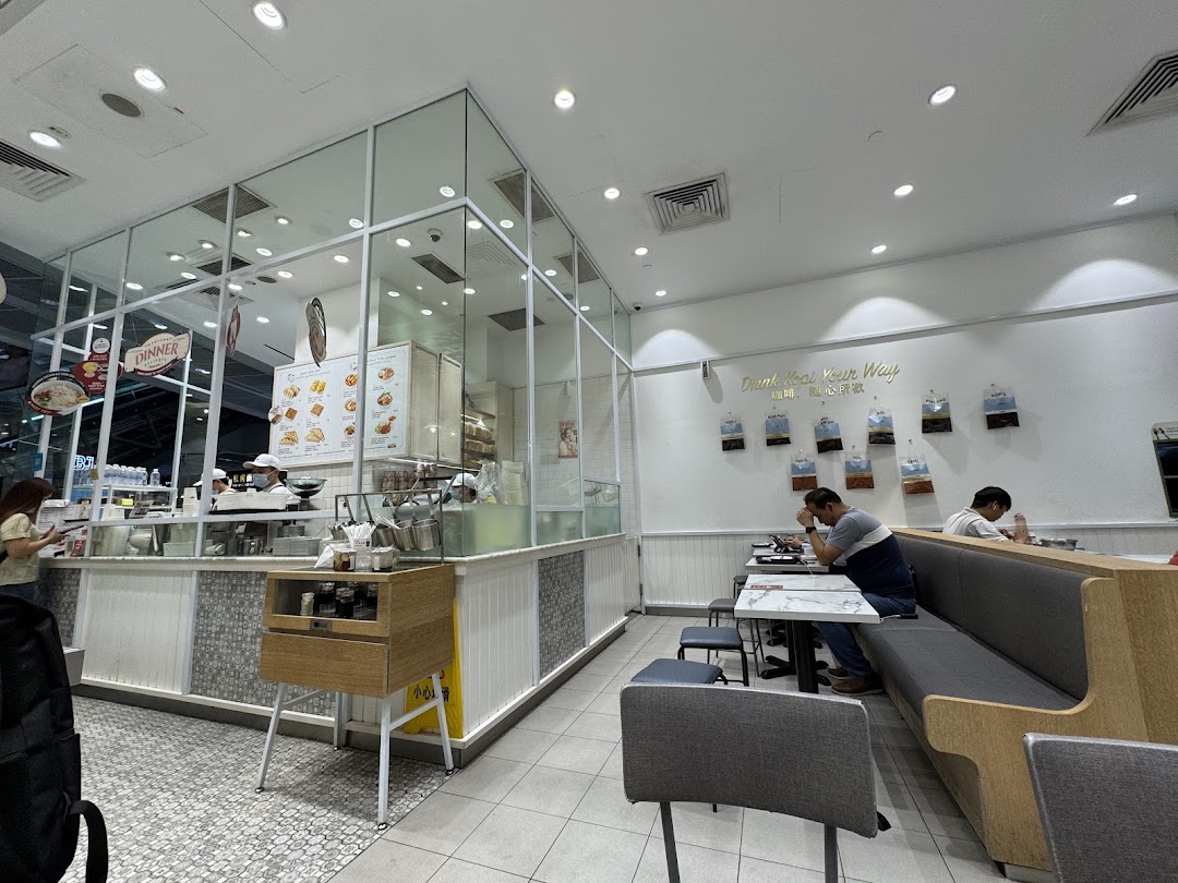 Interior view of Toast Box Funan, showing the counter, dining area, and customers.
