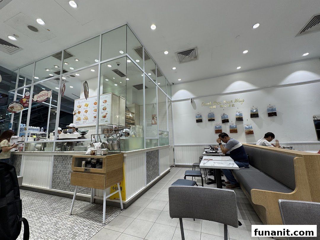Interior view of Toast Box Funan, showing the counter, dining area, and customers.