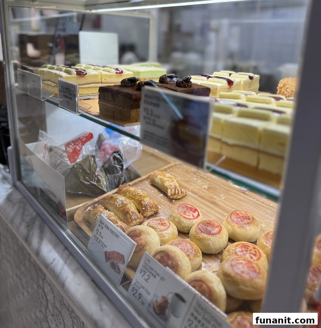 A vibrant display case showcasing a variety of cakes, pastries, and traditional snacks at Toast Box.