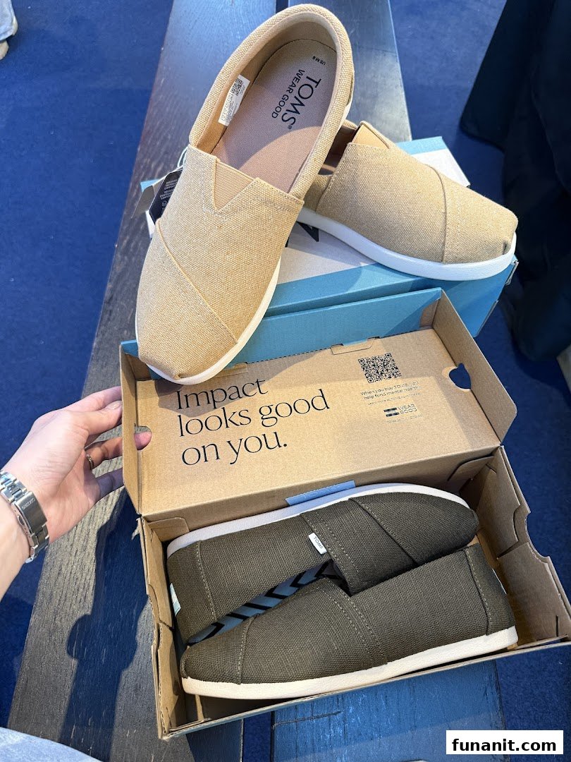 Two pairs of comfortable Toms shoes, one beige and one olive, displayed with their box.