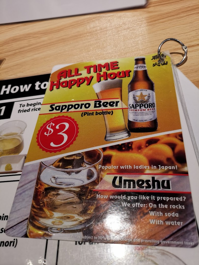 A promotional card displaying an 'All Time Happy Hour' offer for Sapporo Beer and Umeshu.