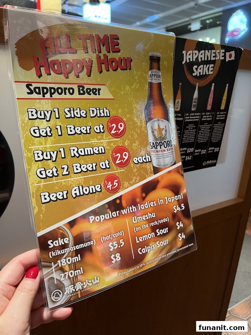 A menu board displaying happy hour deals for Sapporo beer and other Japanese drinks.