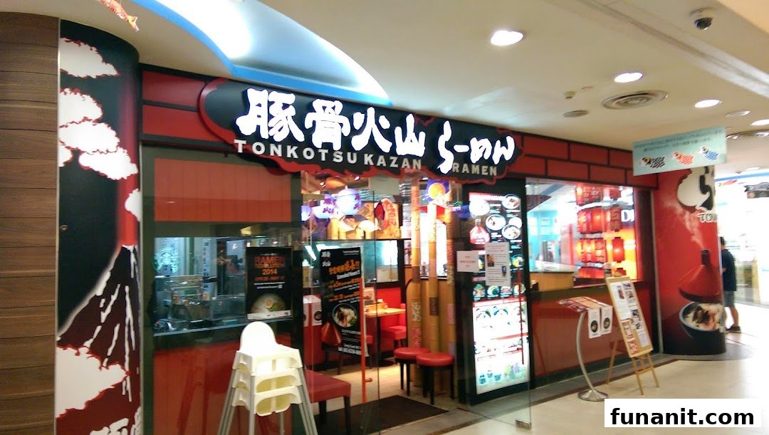 The vibrant red and black storefront of Tonkotsu Kazan Ramen, inviting diners into its Japanese culinary experience.