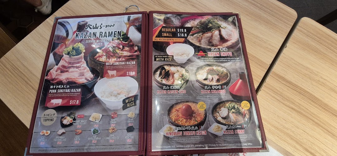A detailed menu displaying various ramen dishes, including Sukiyaki Kazan and specialty ramen, with prices and toppings.