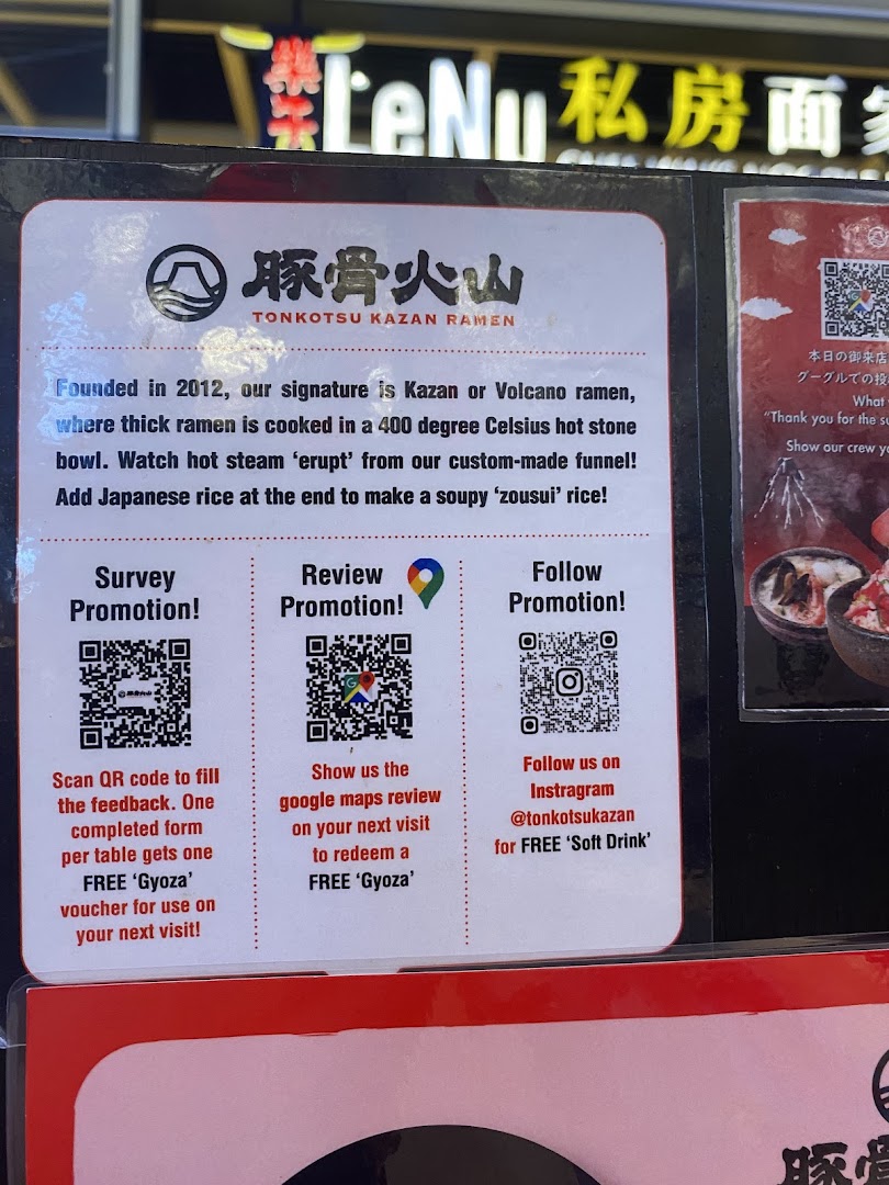A promotional sign for Tonkotsu Kazan Ramen detailing their signature dish and customer promotions.