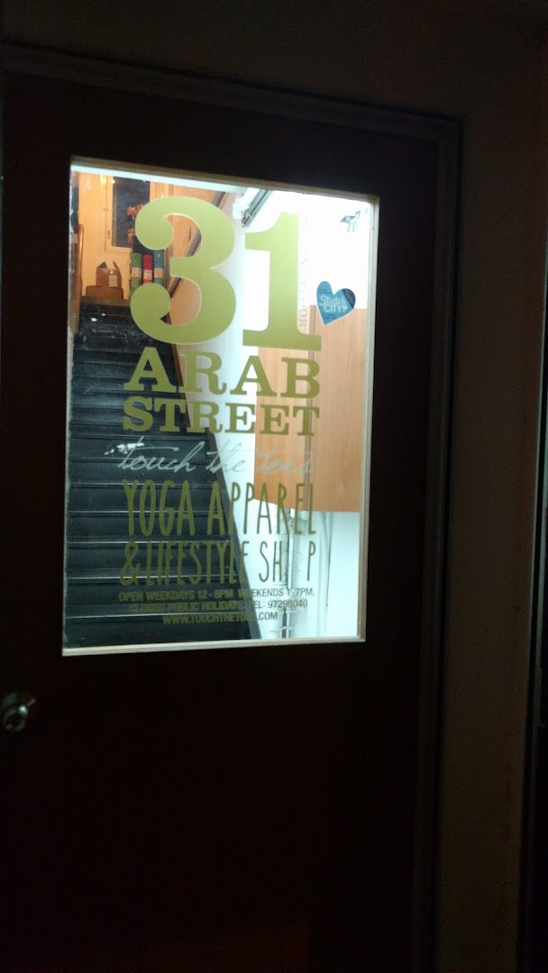 The shop front of 'Touch The Toes' at 31 Arab Street, featuring its yoga apparel and lifestyle offerings.