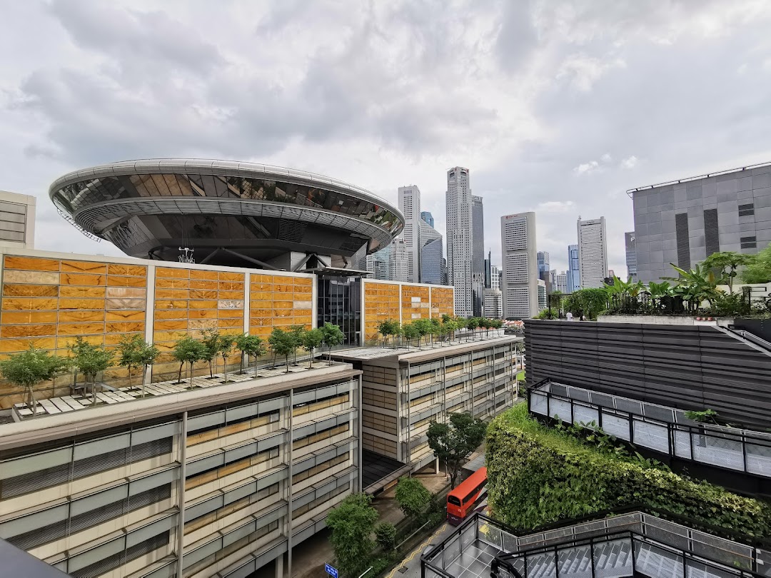 A panoramic view of a city skyline with modern buildings, a distinctive dome structure, and lush rooftop greenery.