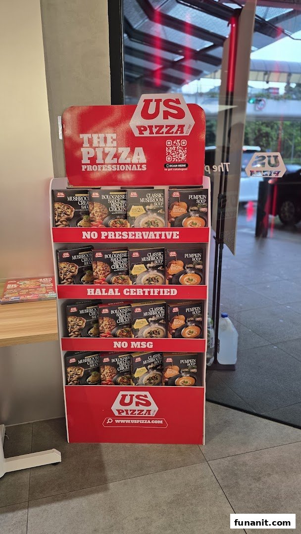 A US Pizza display stand showcasing various ready-to-eat sauces and soups near the shop entrance.