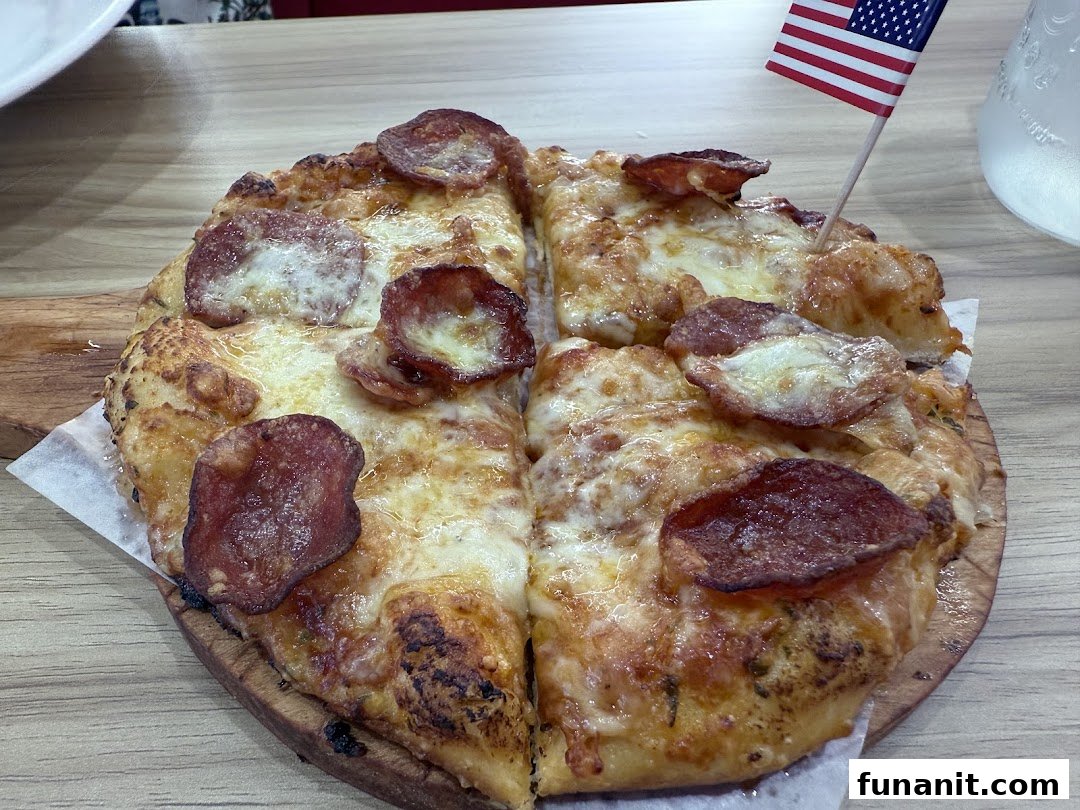A delicious pepperoni pizza served on a wooden board with an American flag pick.
