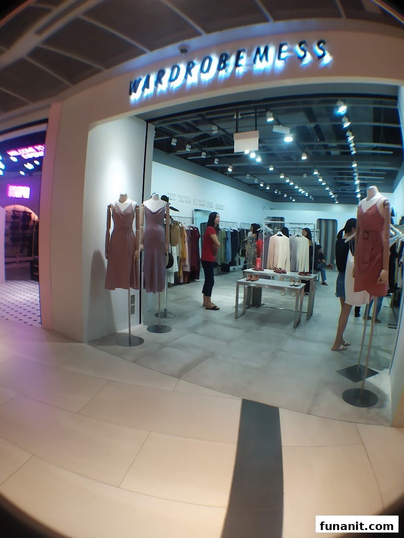 The entrance of Wardrobemess boutique, showcasing stylish dresses on mannequins and a bright interior.