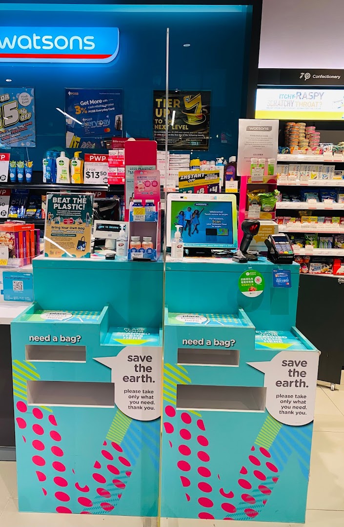An interior view of a Watsons store, featuring checkout counters, product displays, and eco-friendly bag stations.