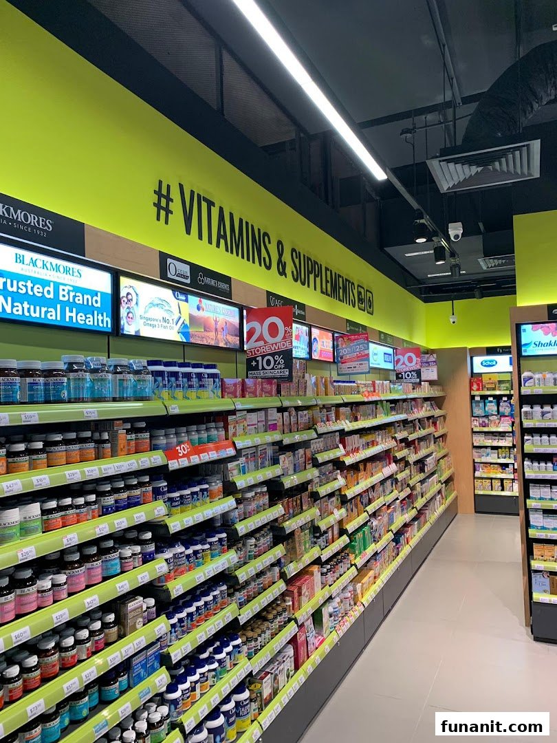 An aisle inside a Watsons/GNC store, brightly lit and stocked with a wide range of vitamins and supplements.