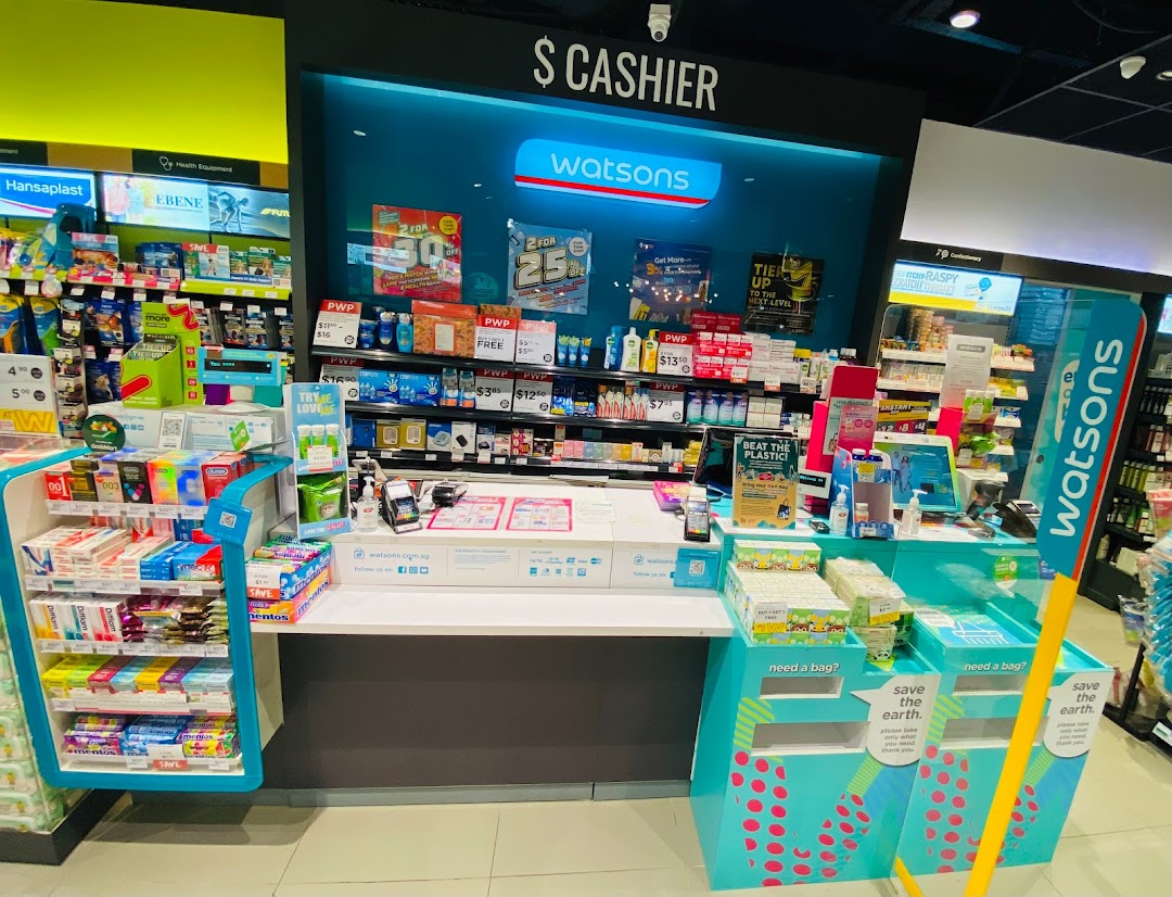 Interior view of a Watsons store, showcasing the cashier counter, health and beauty products, and promotional displays.