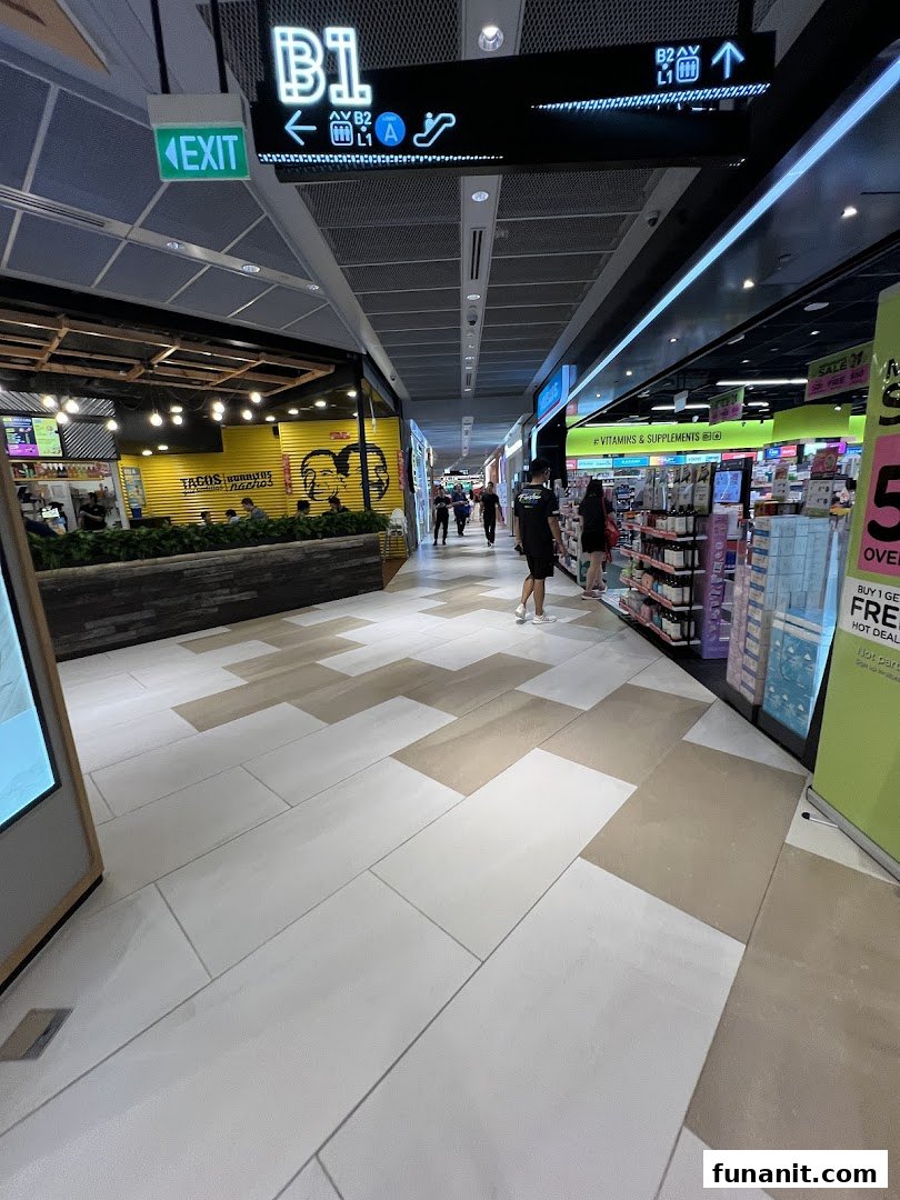 A mall corridor featuring the Watsons/GNC store on the right, offering health and beauty products.