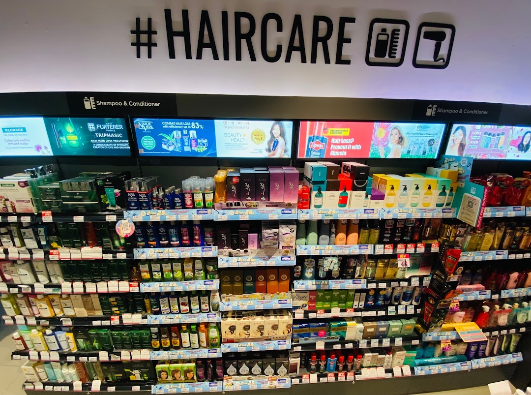 A brightly lit aisle showcasing a wide range of haircare products and solutions in a retail store.