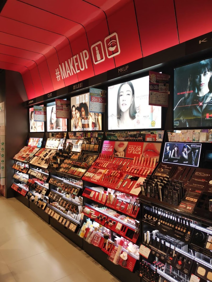 A vibrant display of makeup and beauty products with bright lighting and promotional signage inside Watsons.