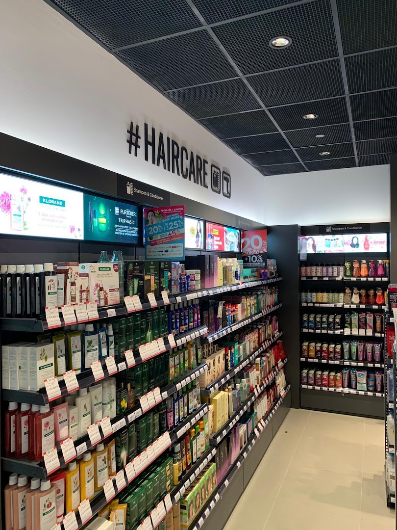An interior view of a Watsons store aisle, showcasing a wide range of hair care products and displays.